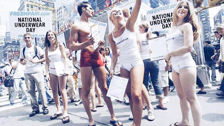 Group of men and women on city street celebrating National Underwear Day Founded by Freshpair